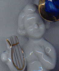 china statuette of C18 gentleman: closeup of cherub