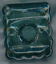 victorian ink bottle: view from top, showing grooves for resting a stick-pen (sort of paint-brush handle, with steel nib inserted into metal band at one end