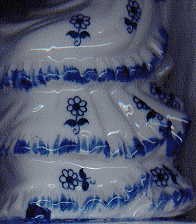 china teaparty ornament: closeup of skirt of right hand lady