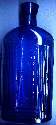 large blue victorian poison bottle.  it says, POISONOUS. NOT TO BE TAKEN.