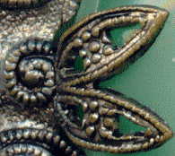 1940s? brooch with green satin glass cabochons: detail showing fancy claw which holds central cabochon