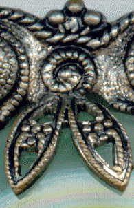 1940s? brooch with green satin glass cabochons: detail showing fancy claw which holds central cabochon, with upper part of metal surround