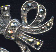 detail of knot from top right of silver marcasite brooch