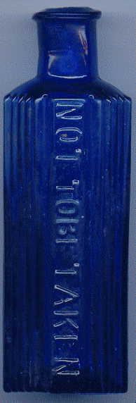 octagonal blue victorian poison bottle: front view. it says, NOT TO BE TAKEN